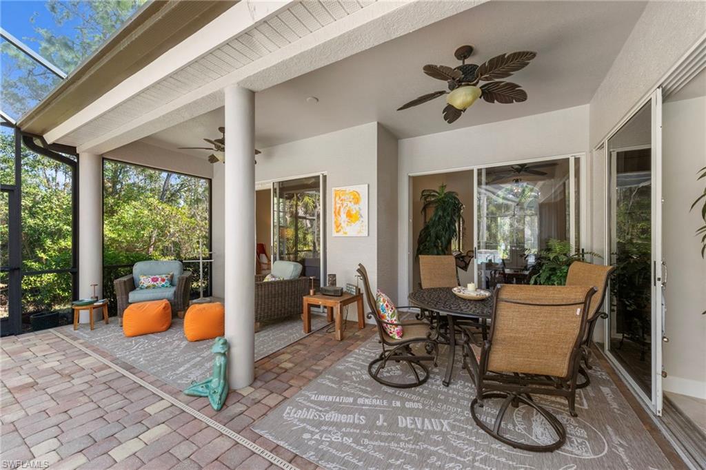 22043 Sycamore Grove Estero, FL 34135 - Photo 33 of 44 a dining room with wooden floor and a potted plant