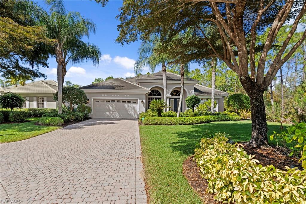 22043 Sycamore Grove Estero, FL 34135 - Photo 4 of 44 a front view of a house with garden