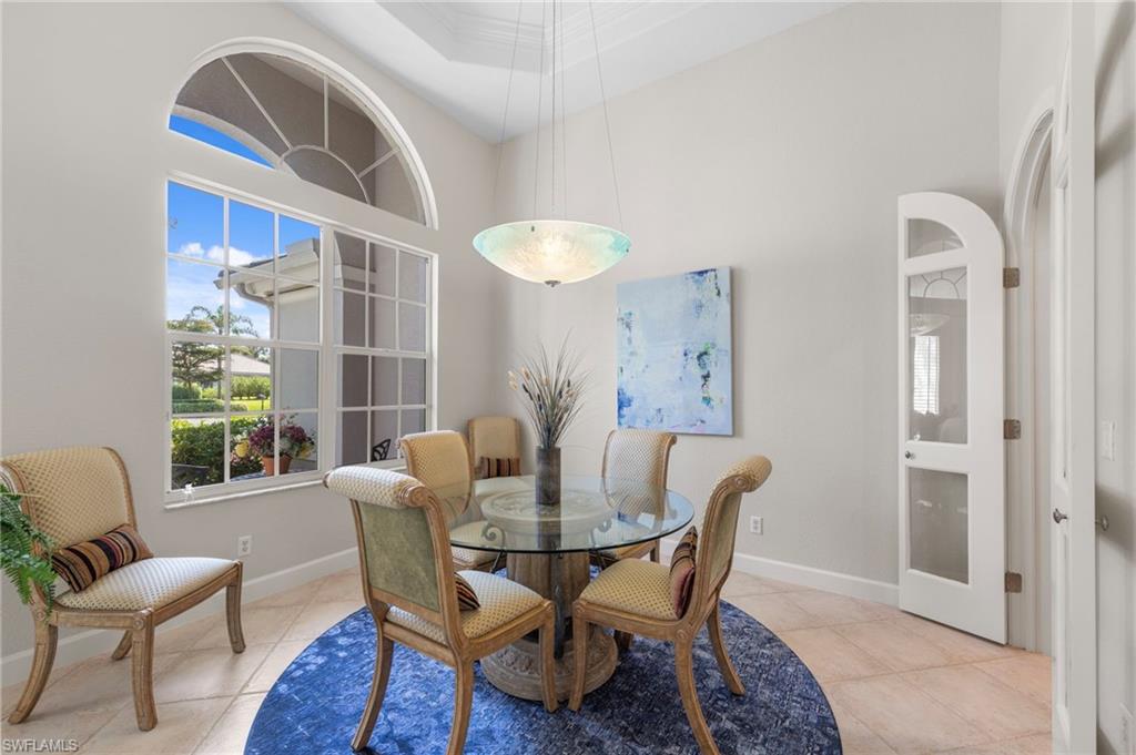 22043 Sycamore Grove Estero, FL 34135 - Photo 7 of 44 a dining room with furniture a chandelier and wooden floor