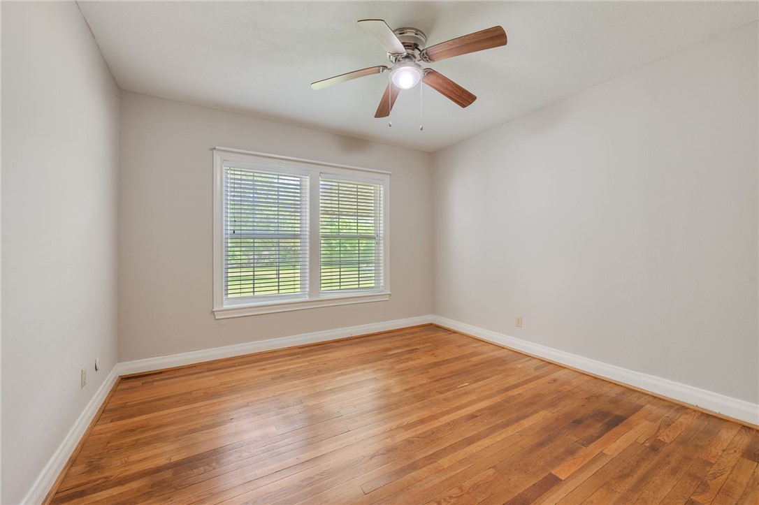 715 Inwood Drive Bryan, TX 77802 - Photo 26 of 34 wooden floor in an empty room with a window