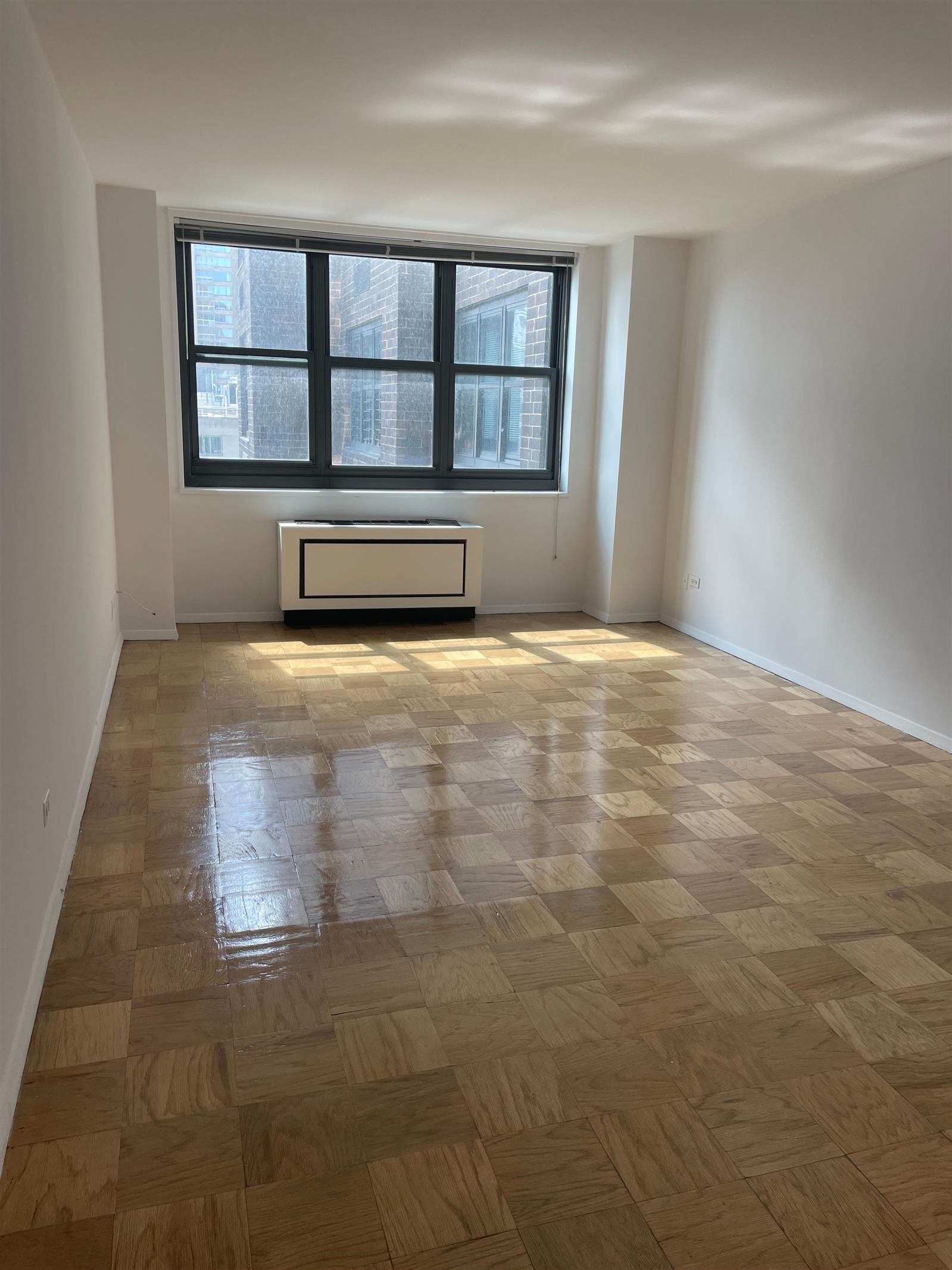 200 East 72nd Street, Unit 22D Manhattan, NY 10021 - Photo 6 of 10 a view of an empty room with a window