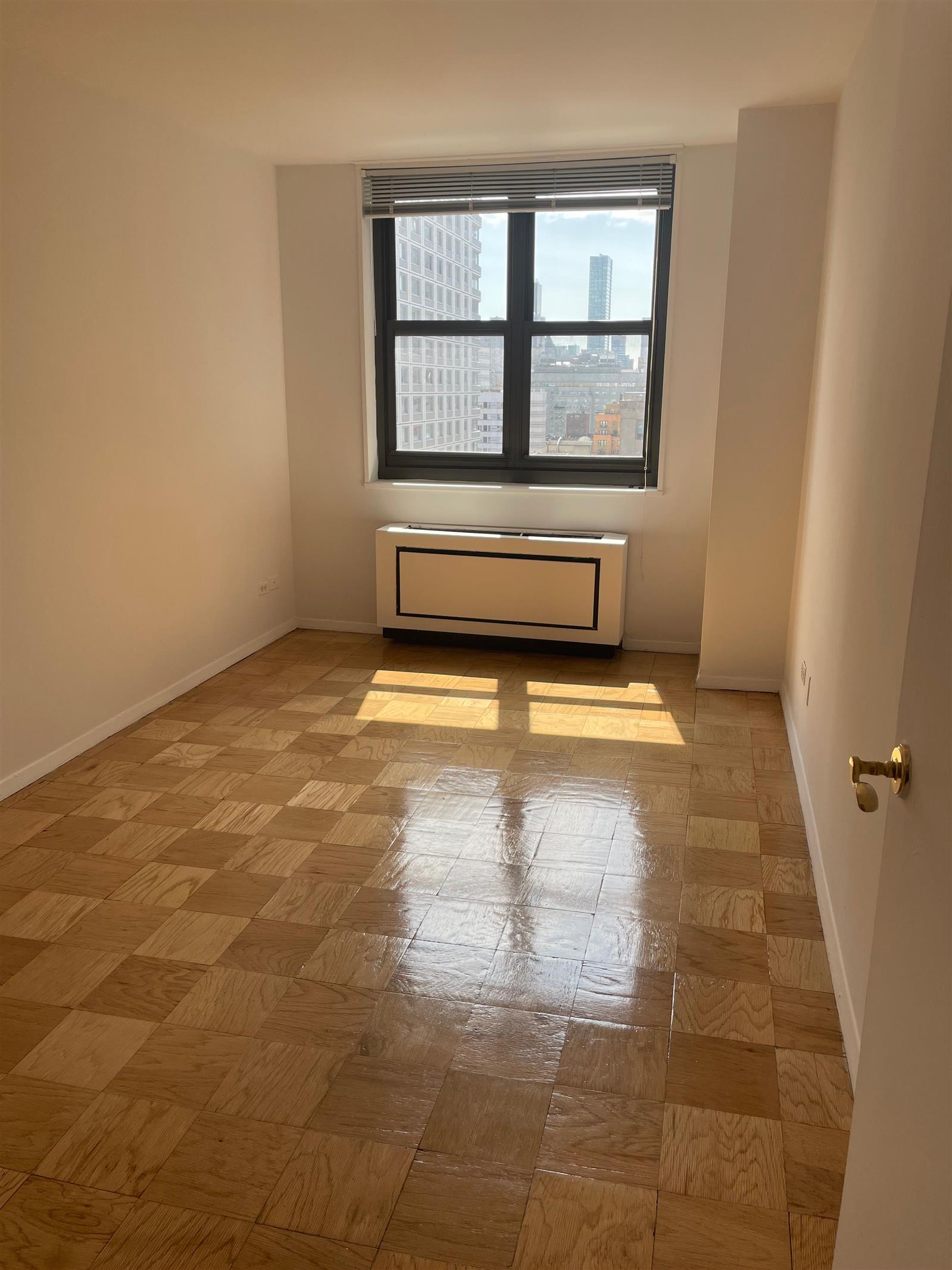 200 East 72nd Street, Unit 22D Manhattan, NY 10021 - Photo 7 of 10 a view of an empty room with a window