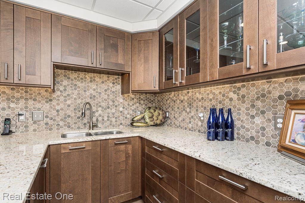 1218 Creekview Court Rochester, MI 48306 - Photo 22 of 48 Granite Counter with Glass Lit Cabinets