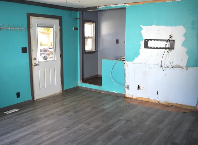 a view of a room with wooden floor and windows