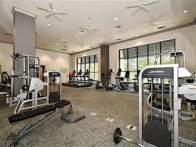 a room with gym equipment and windows
