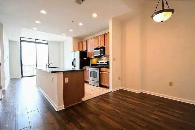 a kitchen with stainless steel appliances granite countertop a stove a sink and a refrigerator