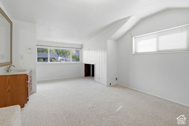 380 North 300 East Mapleton, UT 84664 - Photo 17 of 35 White wall finishes, sloped ceiling, built-in vanity with a sink, built-in storage cabinet, and multiple windows