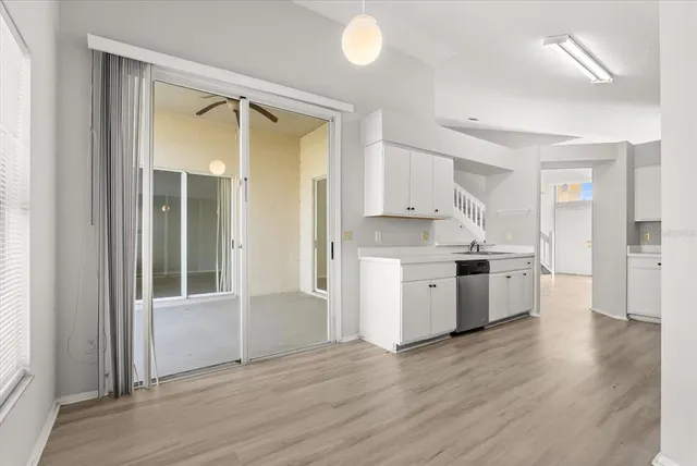 a kitchen with a refrigerator a sink and a stove top oven