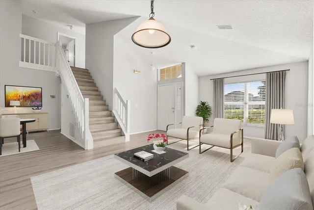 a living room with furniture and a floor to ceiling window