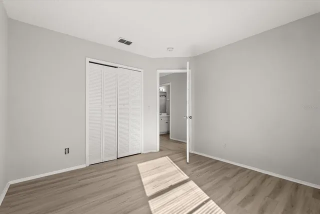 a view of an empty room and wooden floor