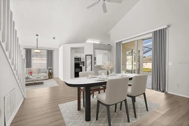 a view of a dining room with furniture and wooden floor