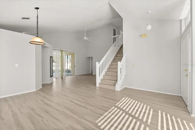 a view of empty room with wooden floor