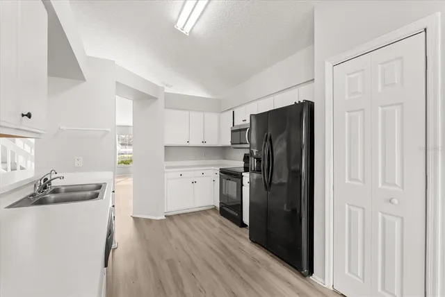 a kitchen with a refrigerator stove and sink