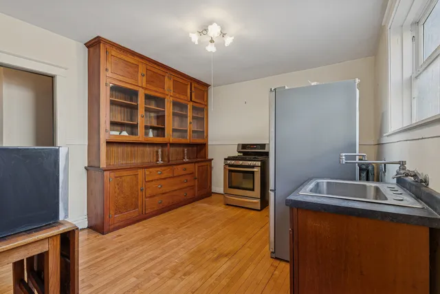a kitchen with a refrigerator sink and cabinets