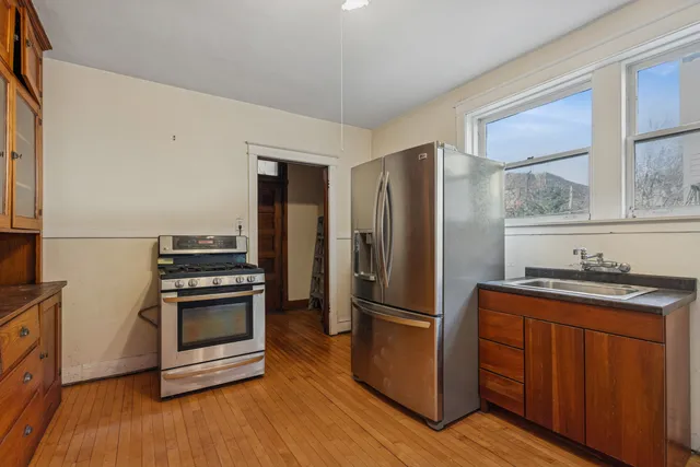 a kitchen with wooden cabinets and stainless steel appliances