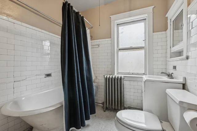 a bathroom with a toilet a sink and shower
