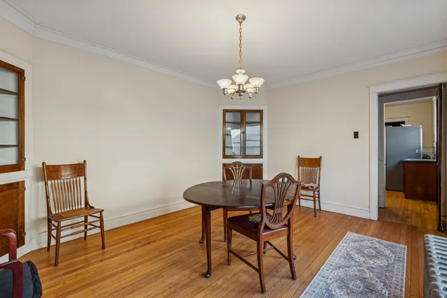 a view of a livingroom with furniture wooden floor and a chandelier