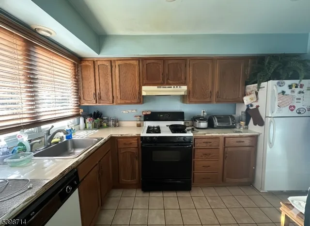 a kitchen with a sink window and cabinets