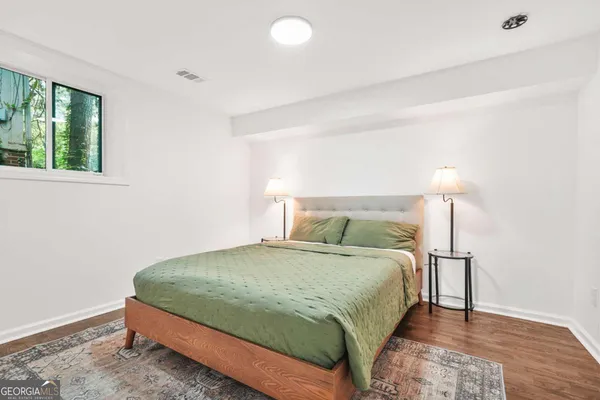 a bedroom with a bed and a lamp