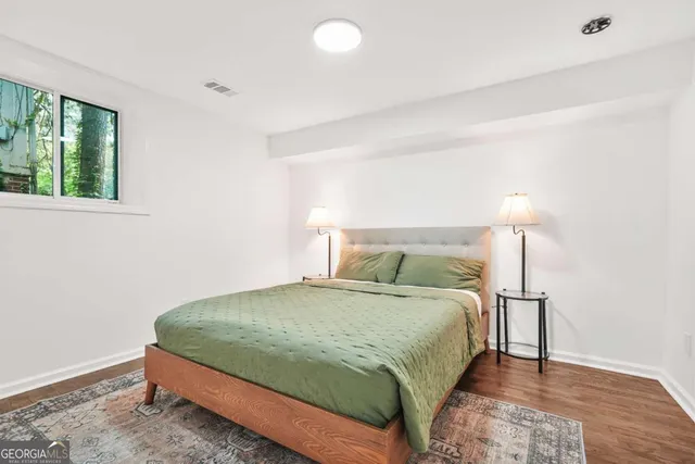 a bedroom with a bed and a lamp