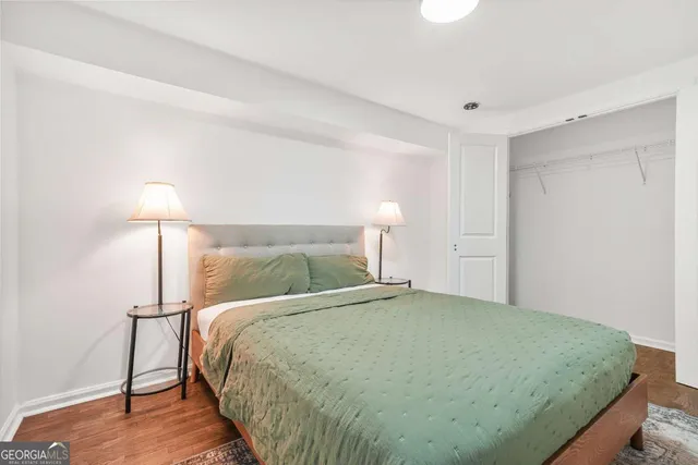 a bedroom with a bed and a night stand