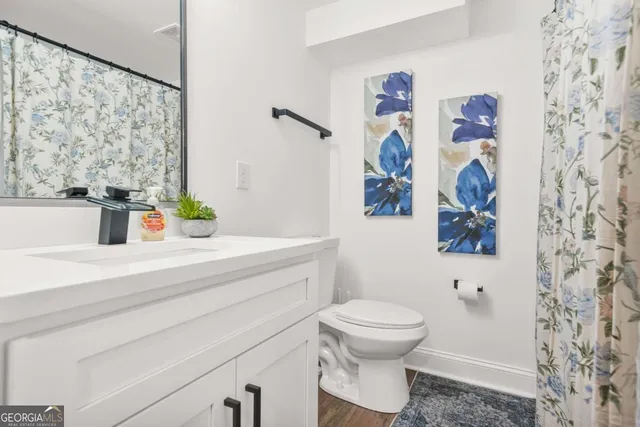 a bathroom with a toilet sink and mirror
