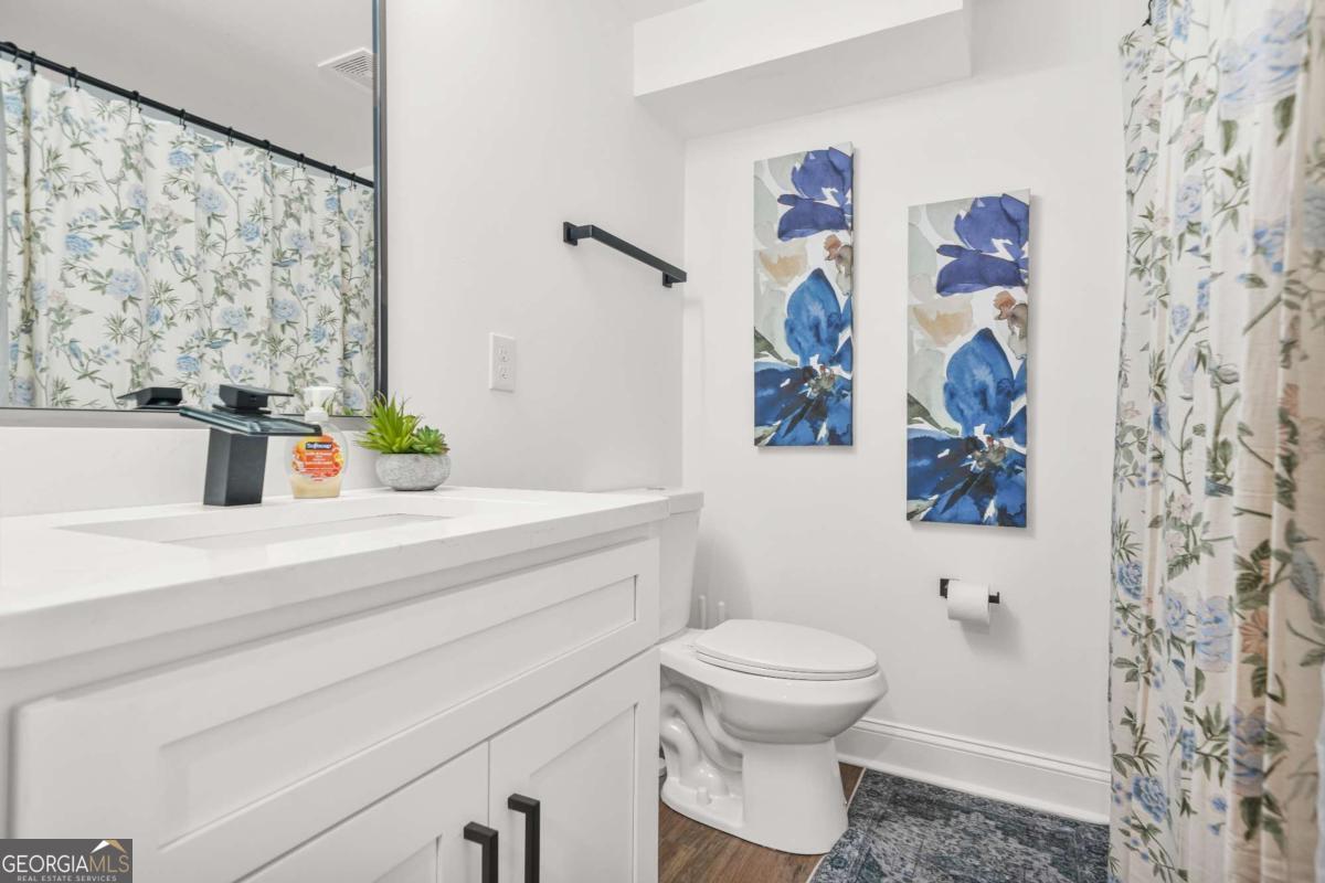 2430 Hanford Drive Southwest Atlanta, GA 30315 - Photo 17 of 21 a bathroom with a toilet sink and mirror
