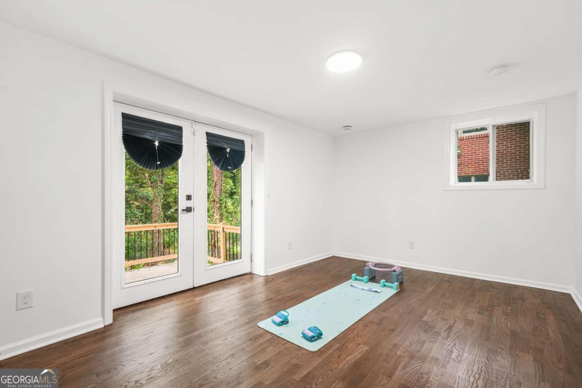 2430 Hanford Drive Southwest Atlanta, GA 30315 - Photo 18 of 21 a view of an empty room with wooden floor and a window