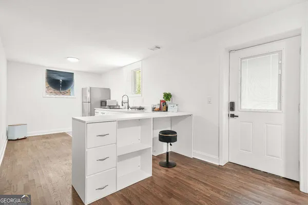 a kitchen with a sink cabinets and wooden floor