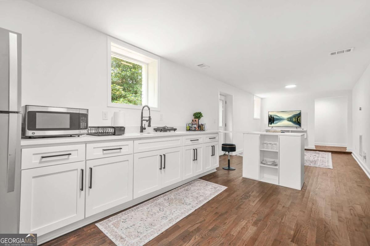 2430 Hanford Drive Southwest Atlanta, GA 30315 - Photo 5 of 21 a kitchen with white cabinets and appliances