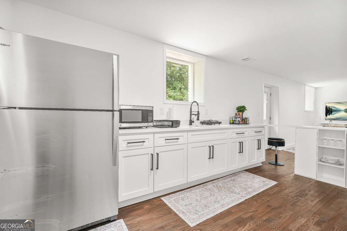 2430 Hanford Drive Southwest Atlanta, GA 30315 - Photo 6 of 21 a kitchen with white cabinets and white appliances
