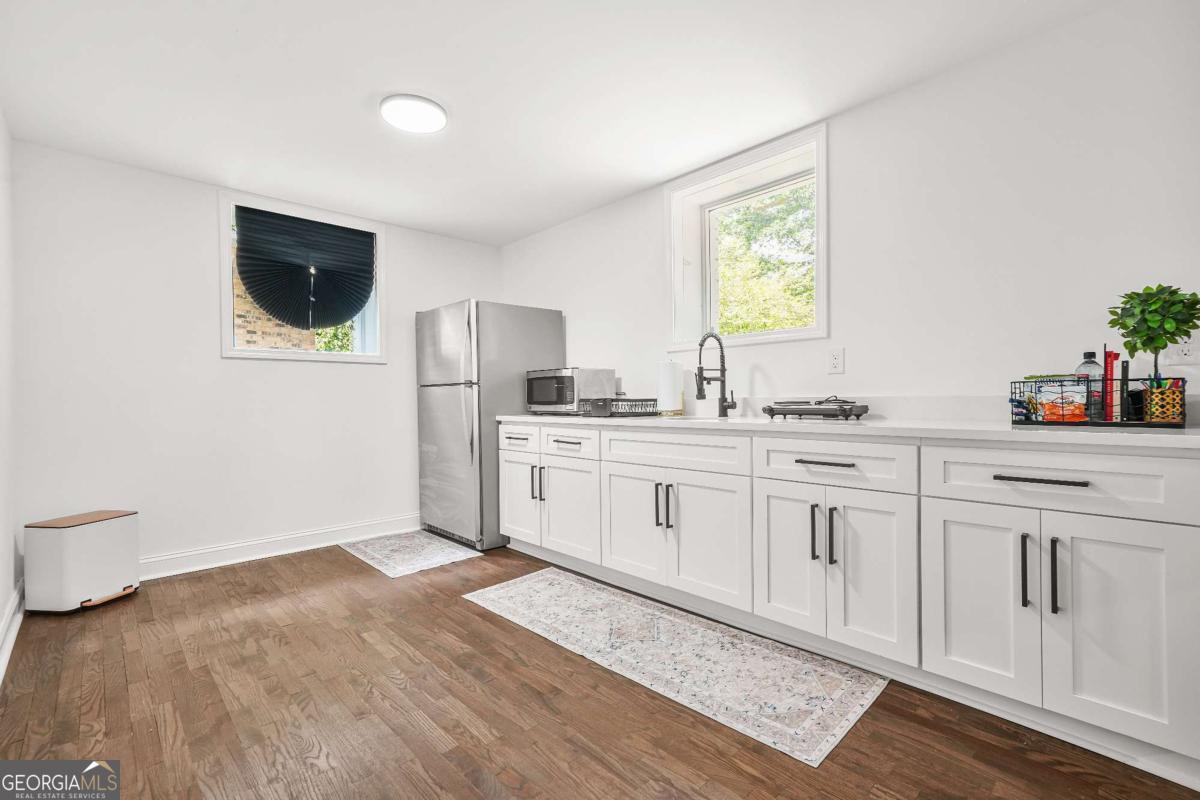 2430 Hanford Drive Southwest Atlanta, GA 30315 - Photo 7 of 21 a kitchen with stainless steel appliances white cabinets and a window