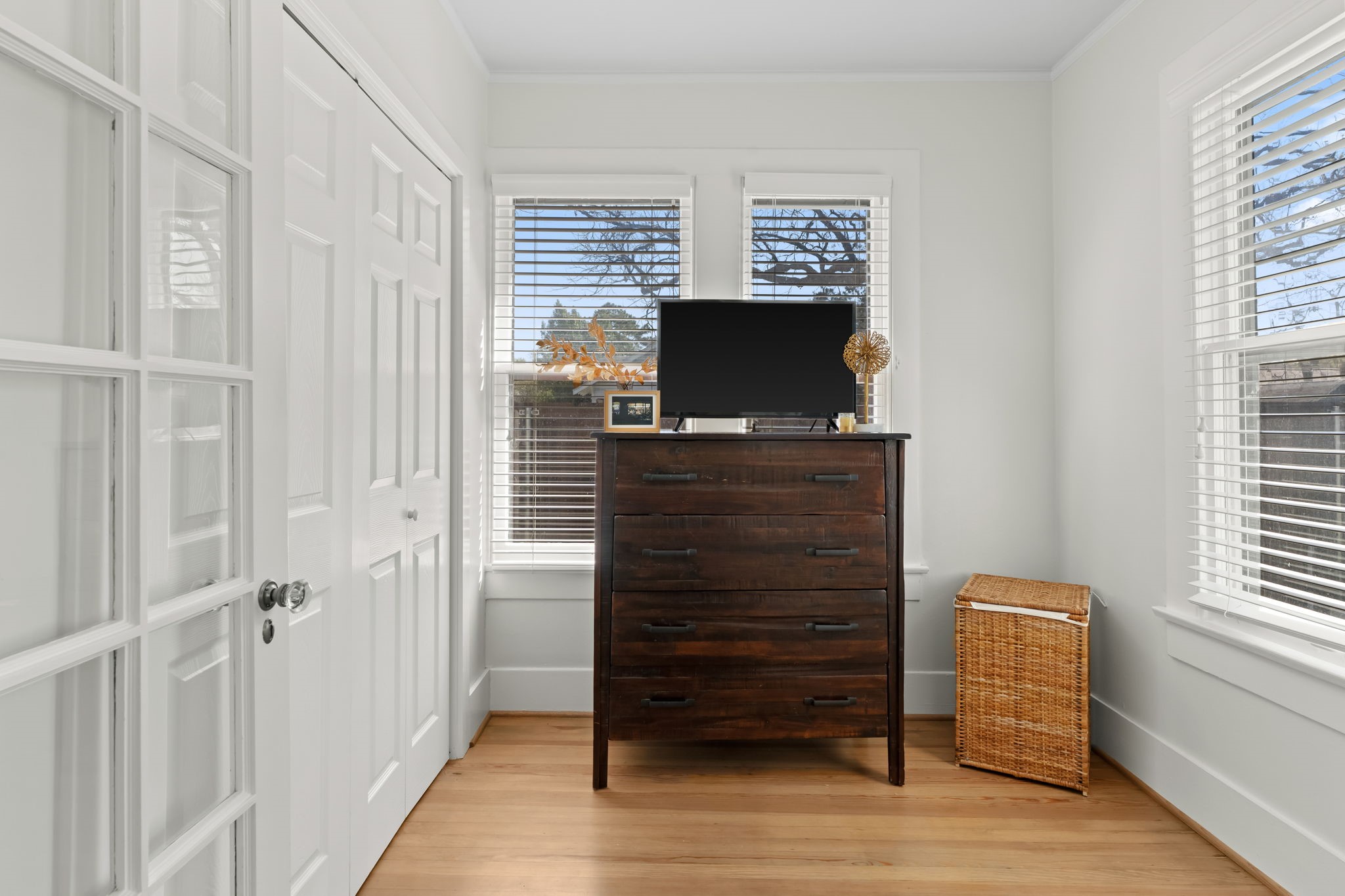 1002 West Cottage Street Houston, TX 77009 - Photo 18 of 37 This windowed nook off the primary bedroom adds flexible square footage, ideal for a reading area, small workspace, or additional storage. Natural light pours in from two exposures, with hardwood floors and a French door connecting back to the primary. It's a practical bonus not often found in homes of this era.