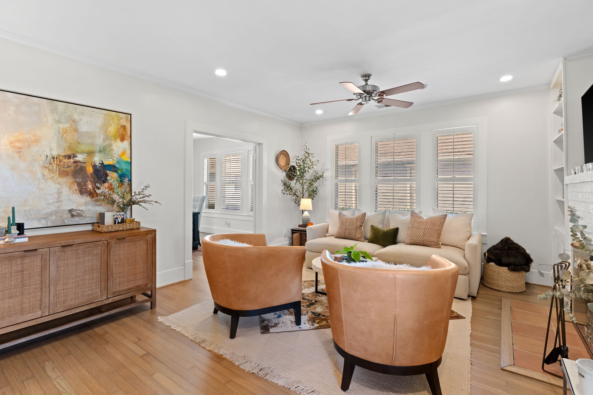 1002 West Cottage Street Houston, TX 77009 - Photo 5 of 37 The main living area features hardwood floors, recessed lighting and crown moulding. A wide cased opening on the left leads to one of the first-floor bedrooms, keeping the layout connected without sacrificing privacy. Ceiling fan and abundant natural light make this room comfortable year-round.