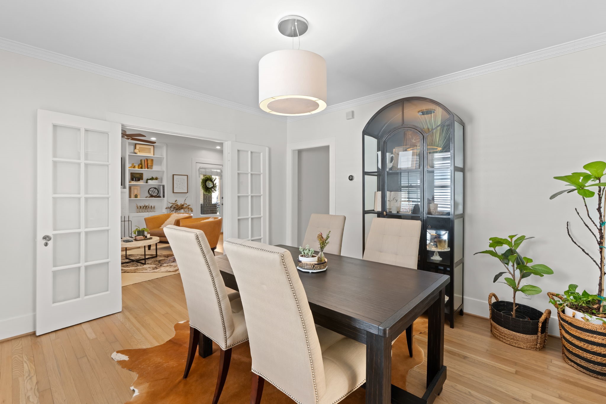 1002 West Cottage Street Houston, TX 77009 - Photo 37 of 37 Another perspective of the dining room showing the French doors fully open to the living room, reinforcing how flexible this floor plan is. The doorway to the hallway is also visible, providing access to the bedrooms and bath without cutting through the kitchen.