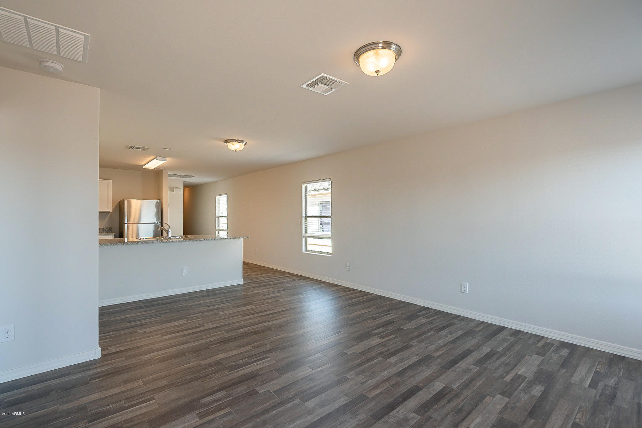944 Starview Avenue Coolidge, AZ 85128 - Photo 13 of 36 a view of empty room with wooden floor and fan
