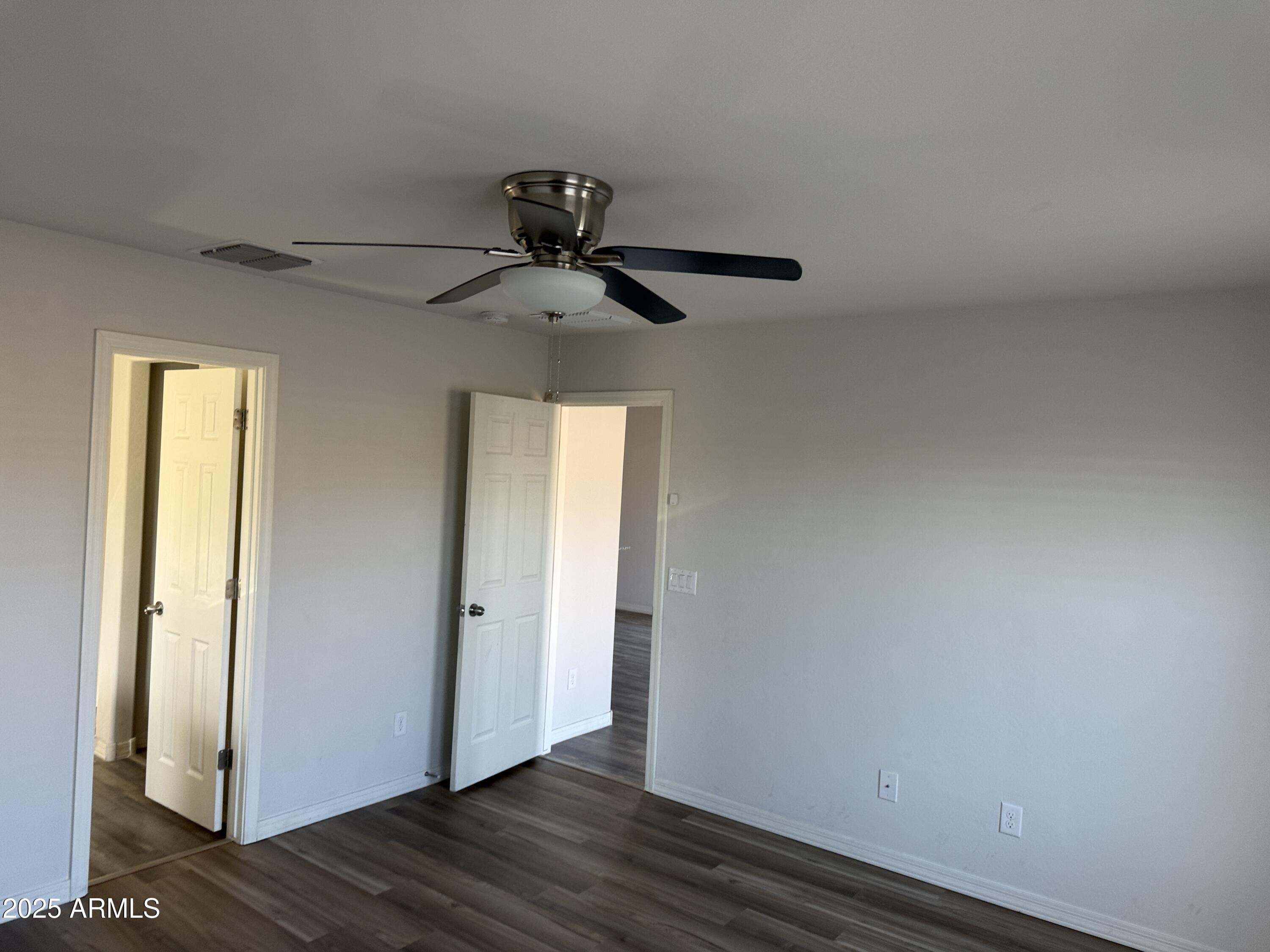 944 Starview Avenue Coolidge, AZ 85128 - Photo 17 of 36 a view of a hallway with wooden floor