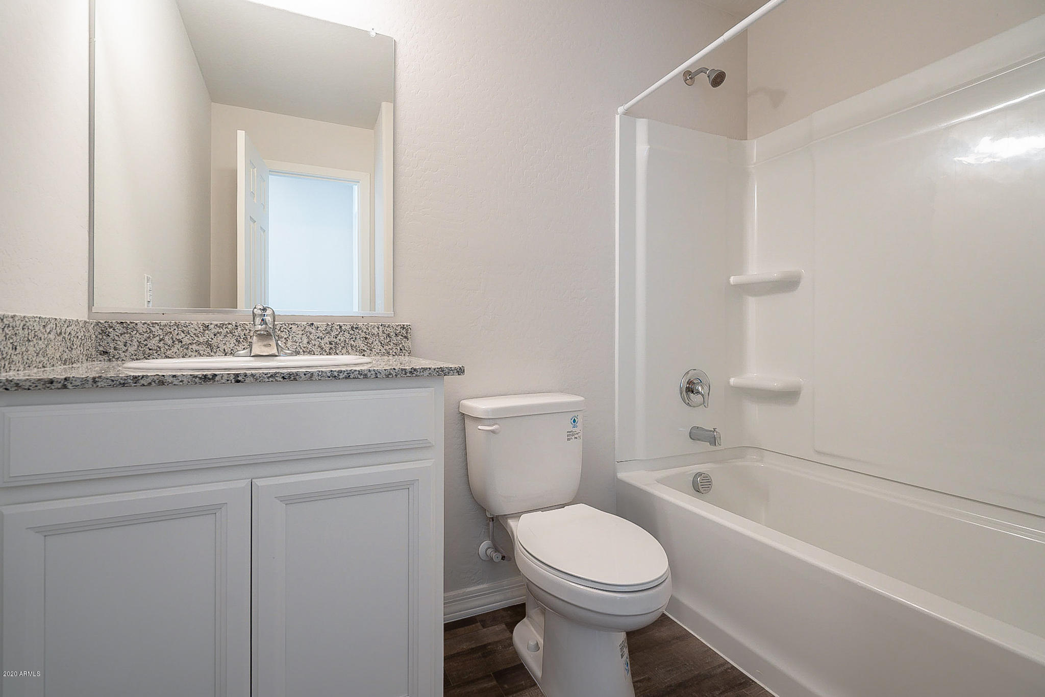 944 Starview Avenue Coolidge, AZ 85128 - Photo 23 of 36 a bathroom with a granite countertop toilet sink and mirror