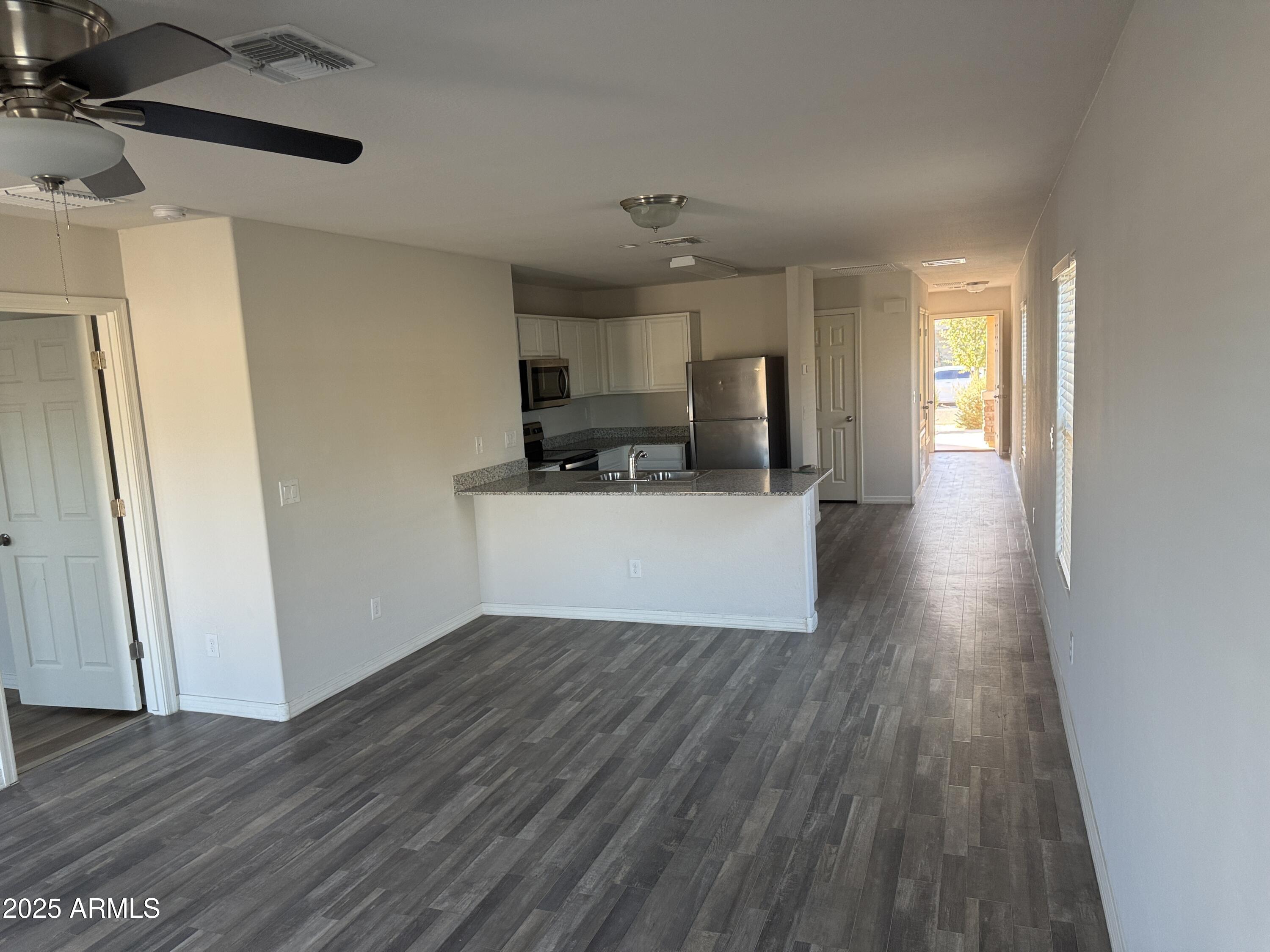 944 Starview Avenue Coolidge, AZ 85128 - Photo 33 of 36 a view of a kitchen with wooden floor and electronic appliances