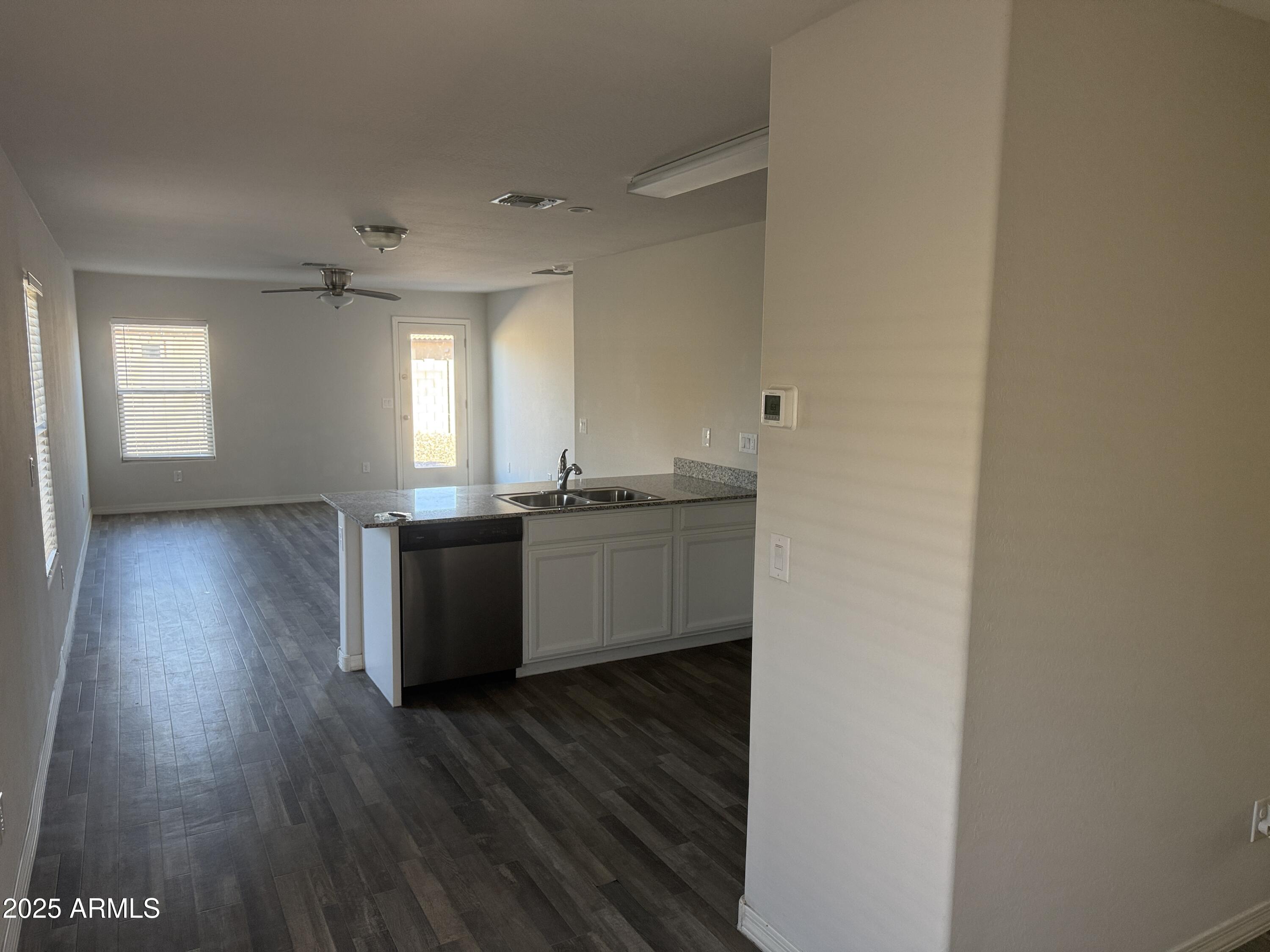 944 Starview Avenue Coolidge, AZ 85128 - Photo 35 of 36 a kitchen with granite countertop a sink and wooden floor