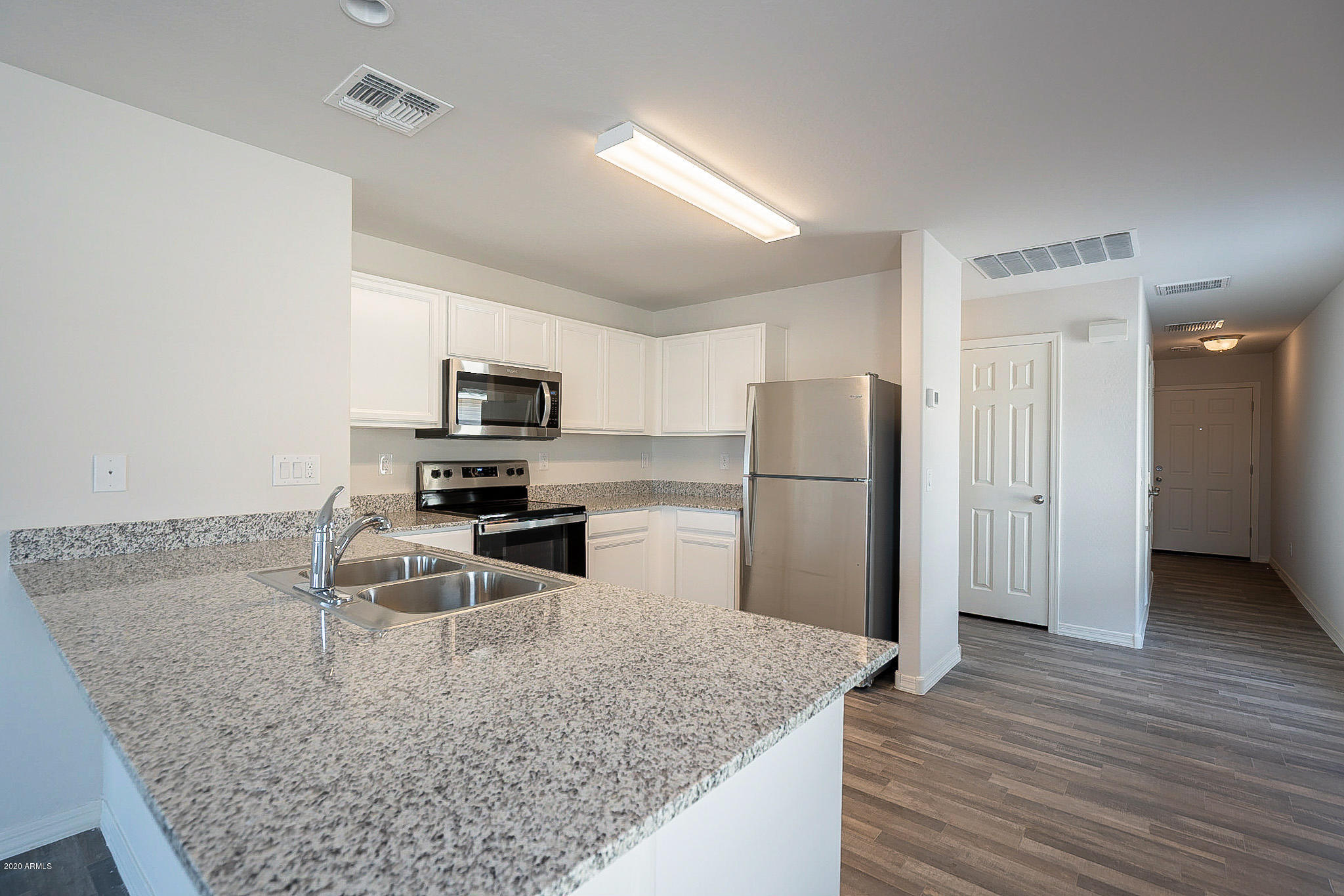 944 Starview Avenue Coolidge, AZ 85128 - Photo 6 of 36 a kitchen with stainless steel appliances granite countertop a refrigerator and a sink