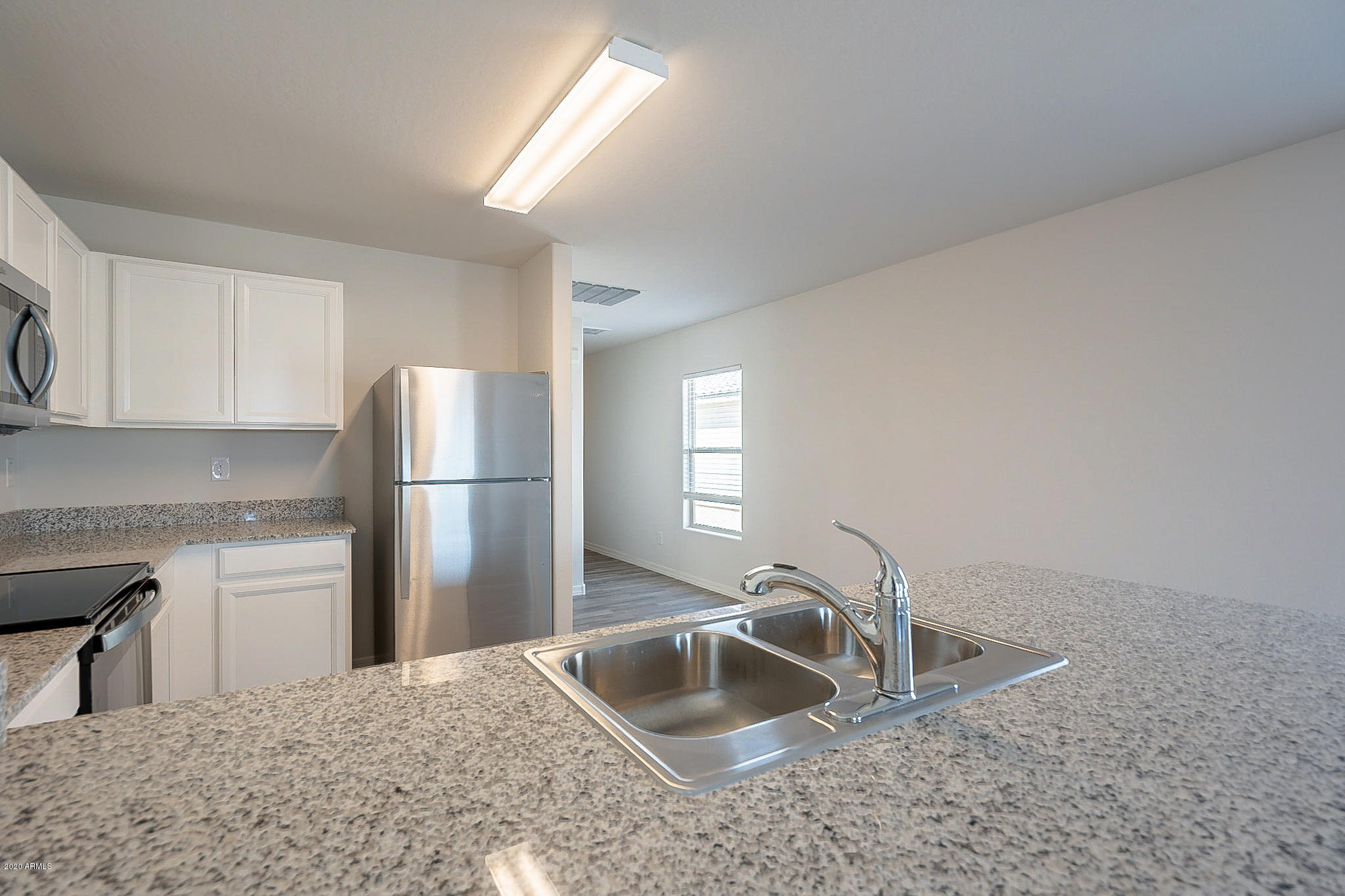 944 Starview Avenue Coolidge, AZ 85128 - Photo 8 of 36 a kitchen with refrigerator cabinets and a sink