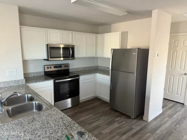 a kitchen with a refrigerator sink and microwave