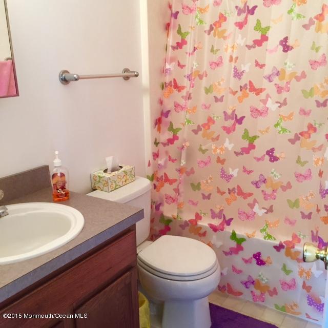 454 Freehold Road Jackson, NJ 08527 - Photo 14 of 18 a bathroom with a sink and mirror with toilet