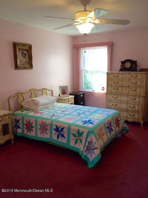454 Freehold Road Jackson, NJ 08527 - Photo 16 of 18 a bedroom with a bed and a window