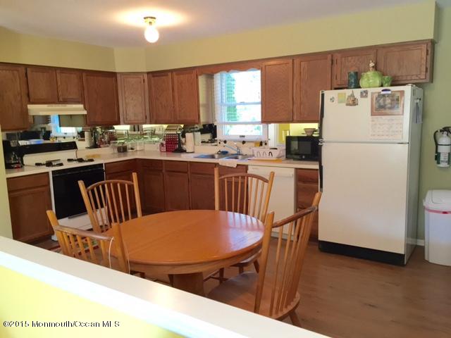 454 Freehold Road Jackson, NJ 08527 - Photo 5 of 18 a kitchen with a table chairs refrigerator and microwave