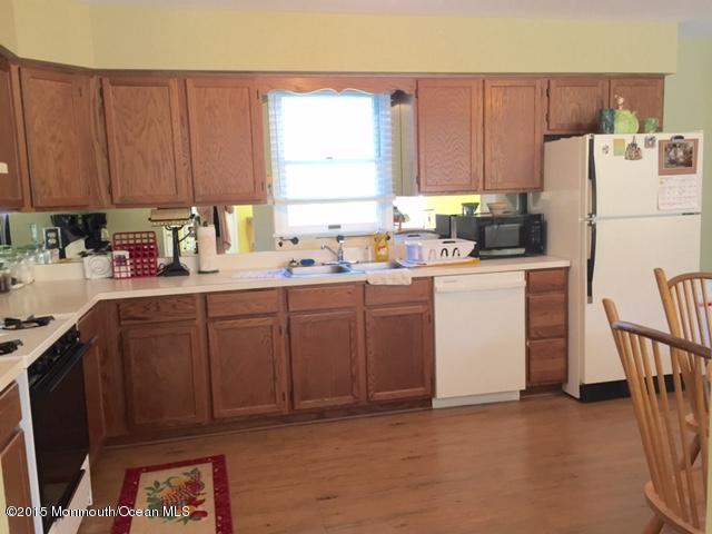 454 Freehold Road Jackson, NJ 08527 - Photo 7 of 18 a kitchen with a sink a refrigerator and cabinets