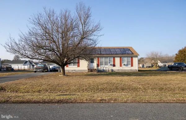 a front view of house with yard and trees
