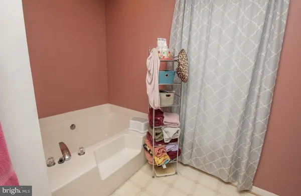 a bathroom with a bathtub and shower