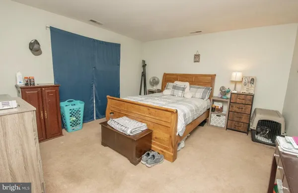 a bedroom with a bed dresser and a window